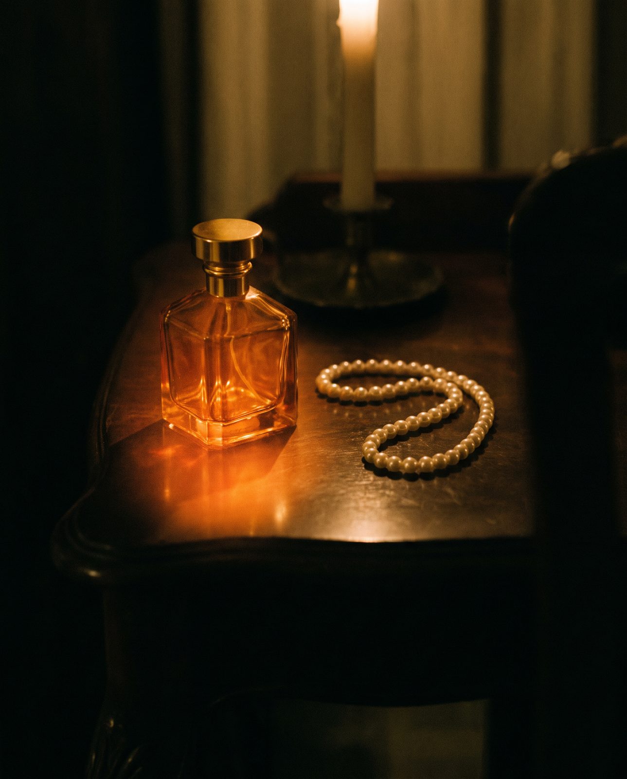 Amber glass and pearls by candlelight